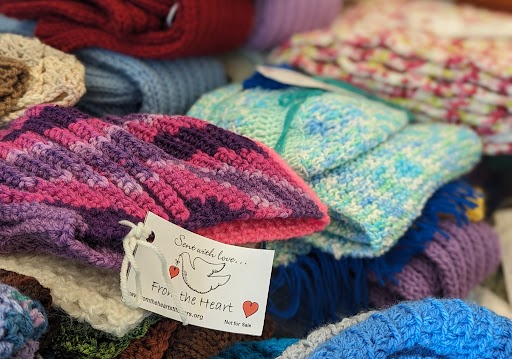 Knitted materials with a tag that states "sent with love from the heart" with a dove holding a heart on the tag
