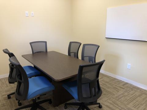 Room B with conference table, chairs and whiteboard
